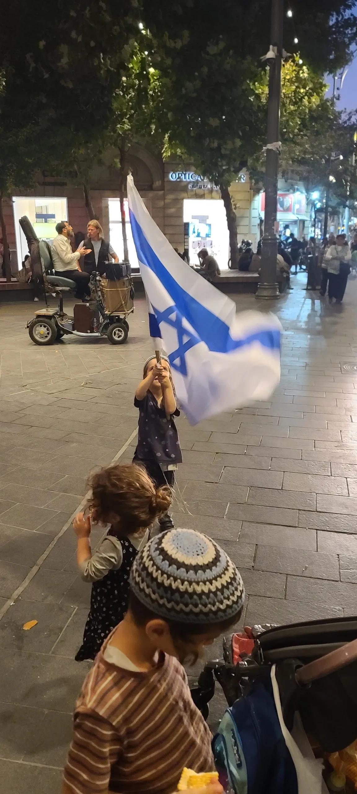 Children playing with flag at night