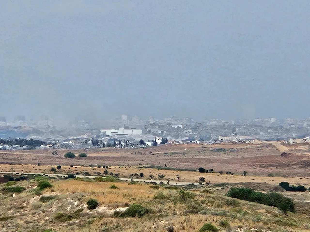 Urban area beyond dry grasslands