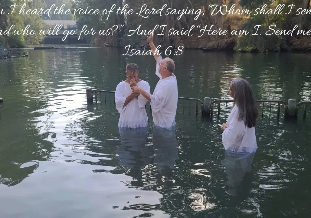 People in white garments during baptism